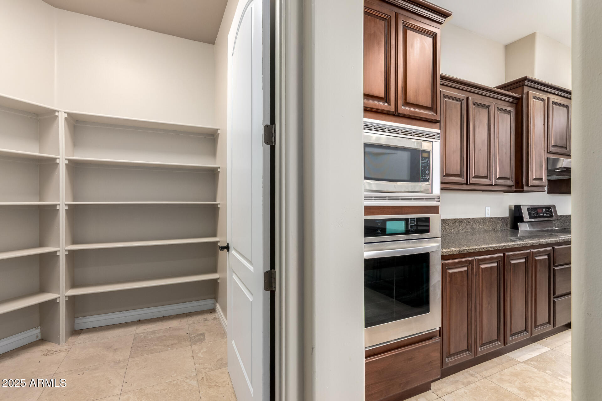 16738 East Lone Mountain Road Scottsdale, AZ 85262 - Photo 35 of 88 a kitchen with stainless steel appliances granite countertop a refrigerator and a stove top oven