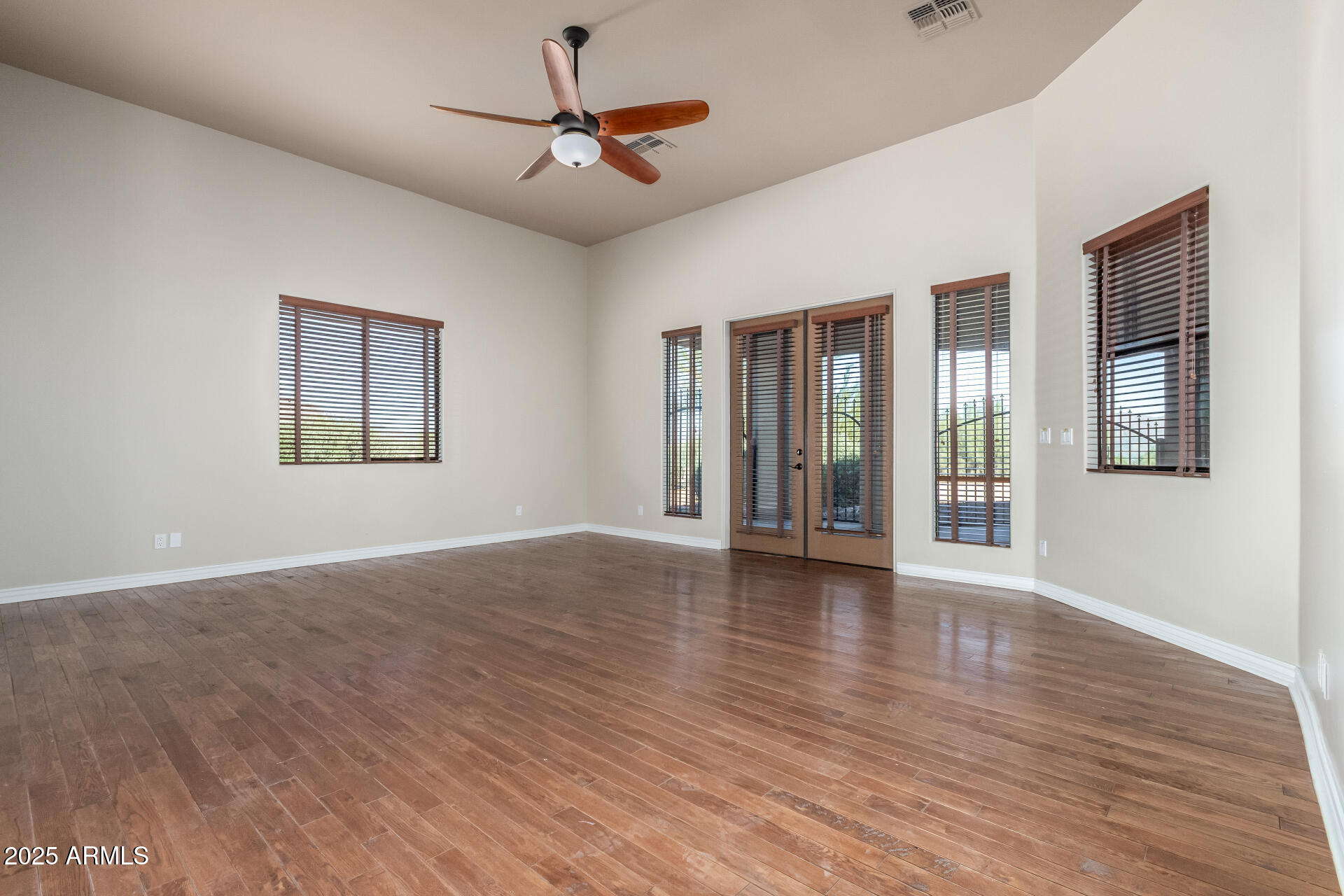 16738 East Lone Mountain Road Scottsdale, AZ 85262 - Photo 38 of 88 a view of an empty room with wooden floor and a window