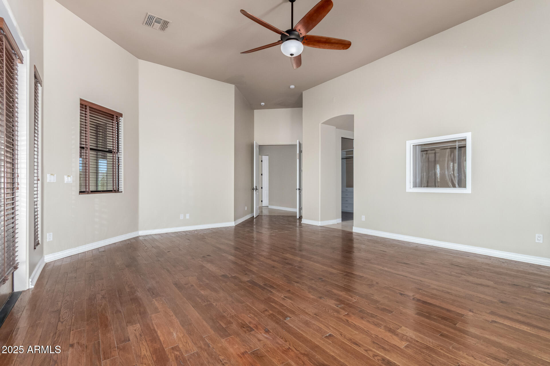 16738 East Lone Mountain Road Scottsdale, AZ 85262 - Photo 40 of 88 a view of an empty room with window and wooden floor
