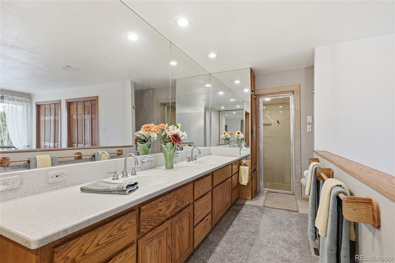 13082 South Wamblee Valley Road Conifer, CO 80433 - Photo 14 of 35 a bathroom with a sink double vanity and a mirror