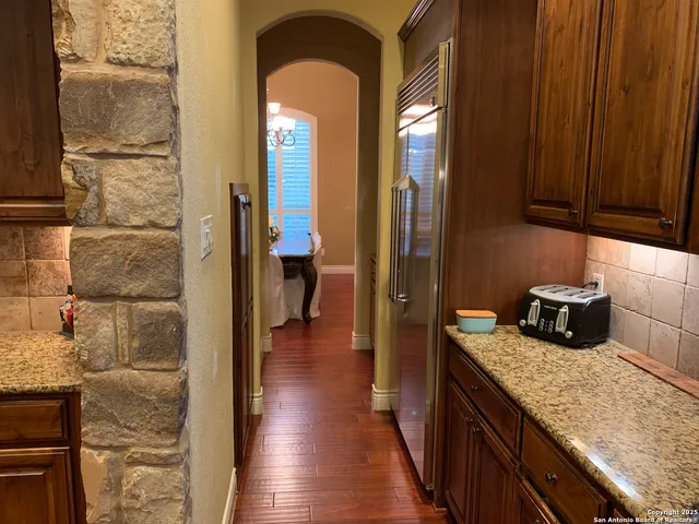 a kitchen with sink and refrigerator
