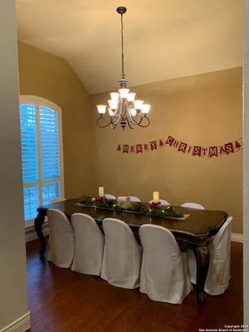 a dinning room with furniture and a chandelier