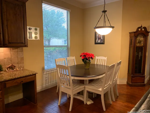 a dining room with furniture a chandelier and wooden floor