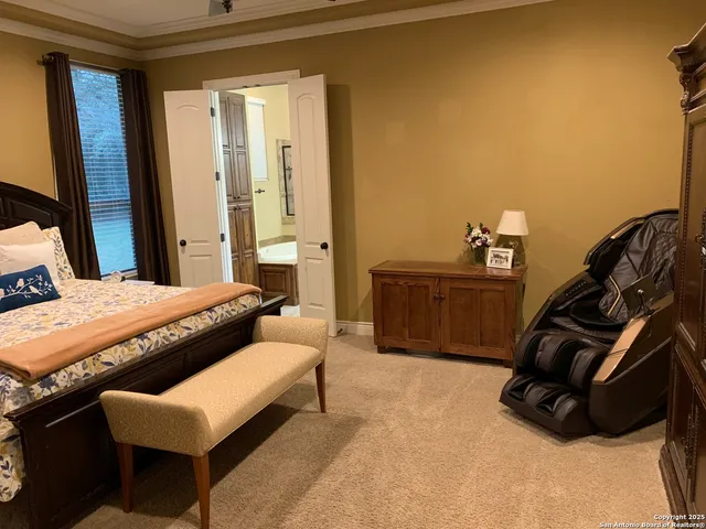 a bedroom with a bed a couch and a dresser