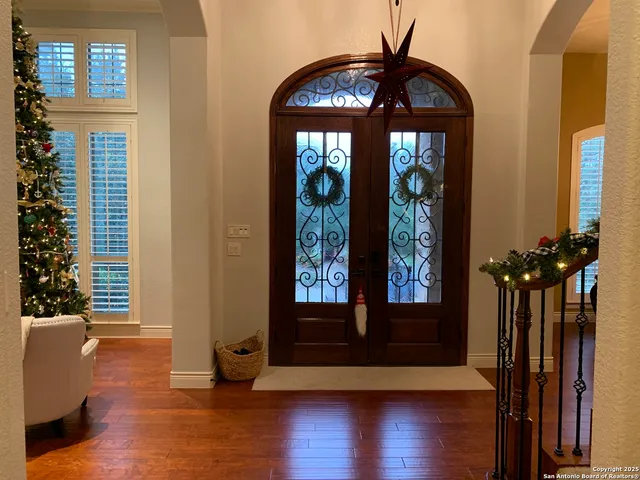 a view of a room with wooden floor and a window
