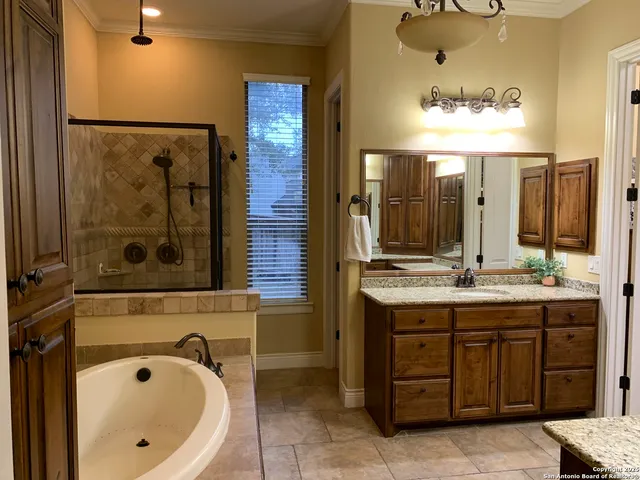 a bathroom with a tub sink and mirror