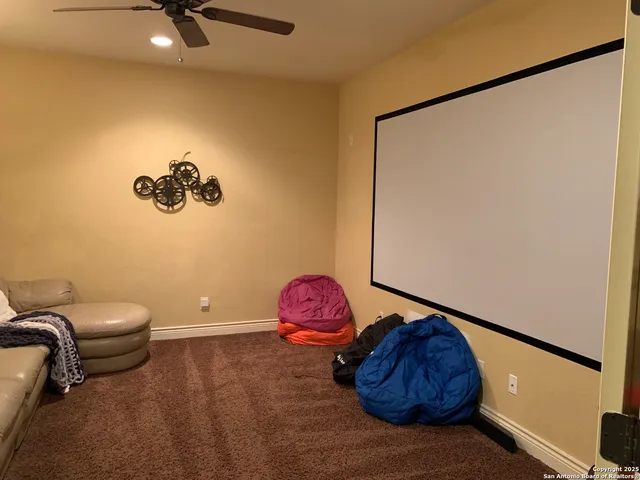 a bath room with a toilet and a mirror