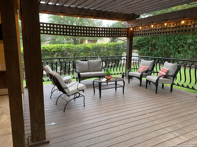 a view of a patio with a table chairs and a backyard