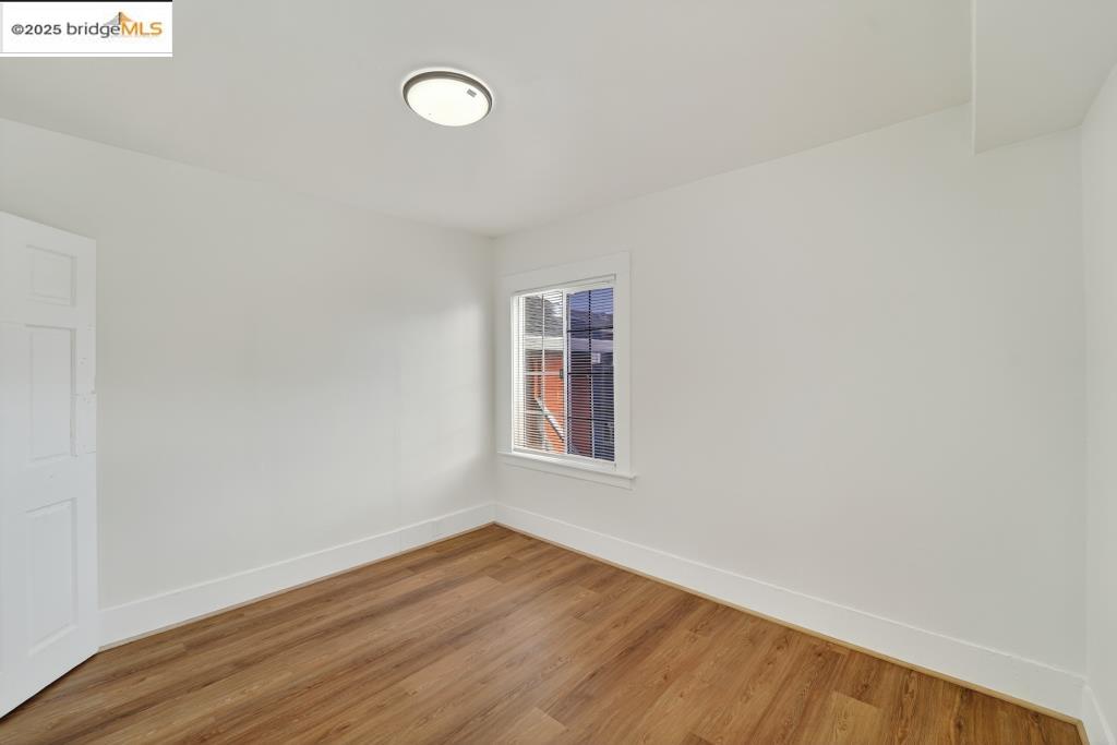 4114 East 17th Street Oakland, CA 94601 - Photo 14 of 39 a view of an empty room with wooden floor and a window