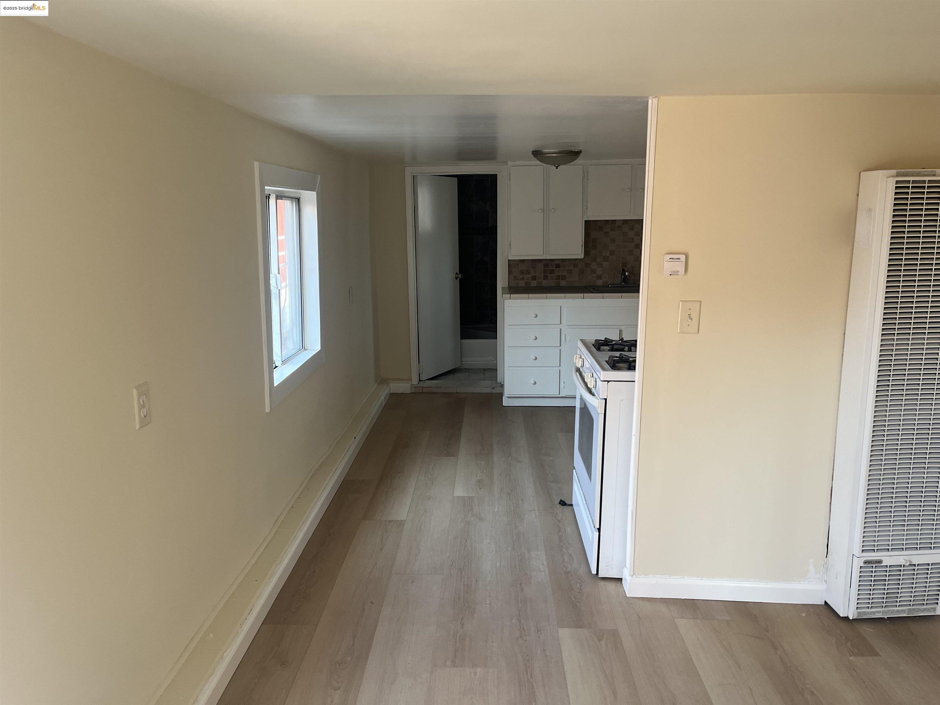 4114 East 17th Street Oakland, CA 94601 - Photo 19 of 39 a view of hallway with wooden floor and a window