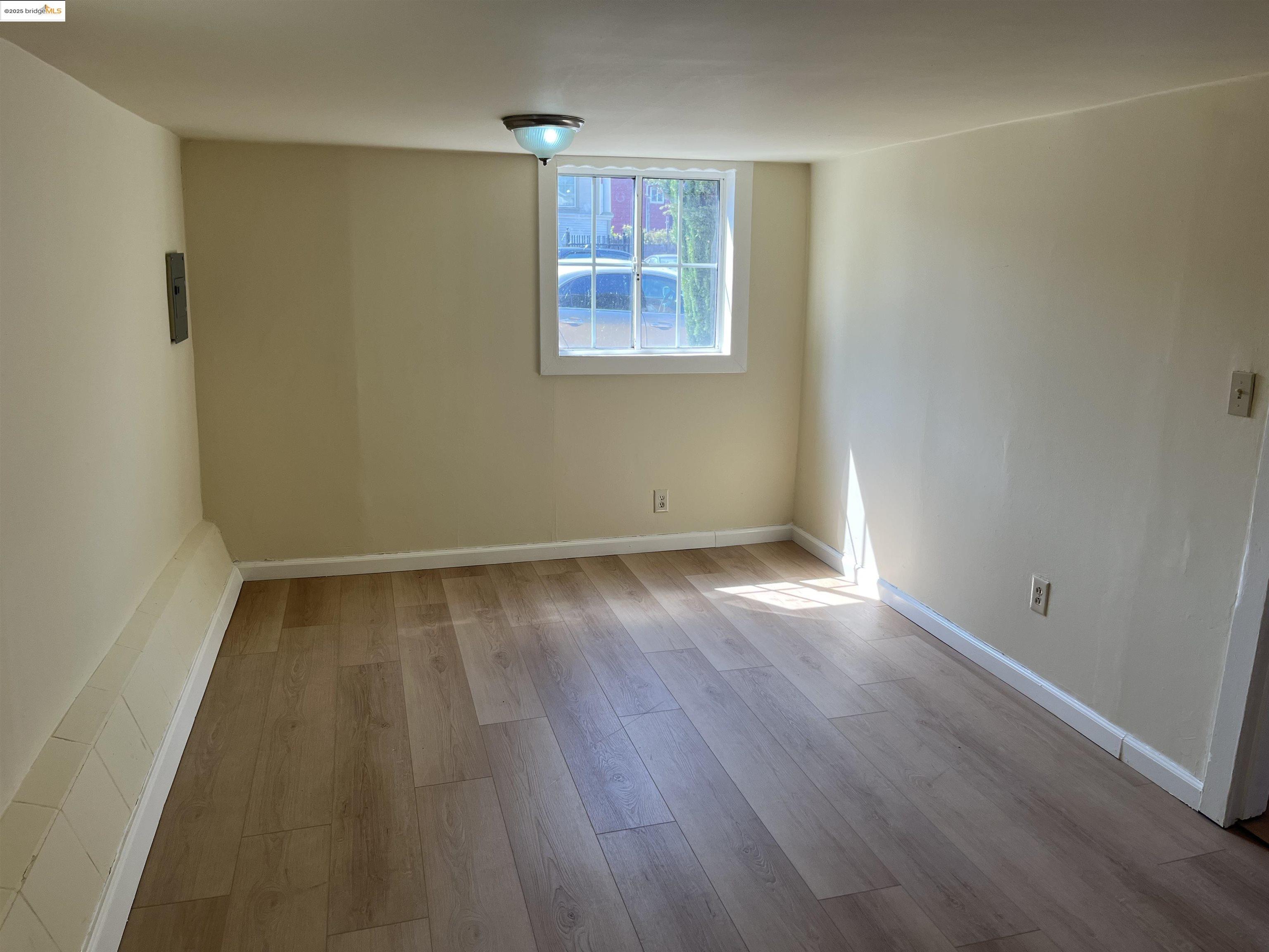 4114 East 17th Street Oakland, CA 94601 - Photo 20 of 39 wooden floor in an empty room with a window