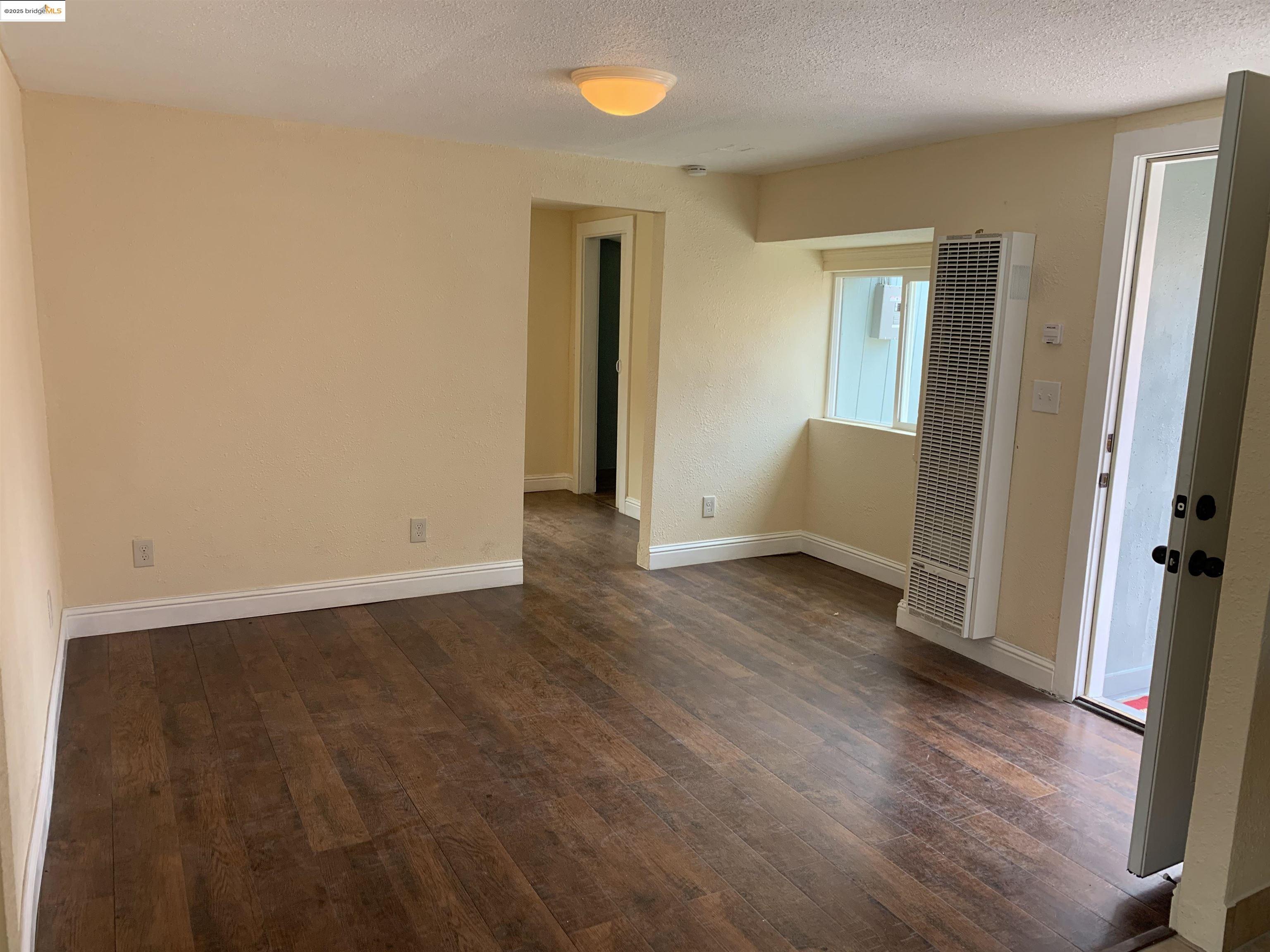 4114 East 17th Street Oakland, CA 94601 - Photo 24 of 39 a view of an empty room with wooden floor and a window