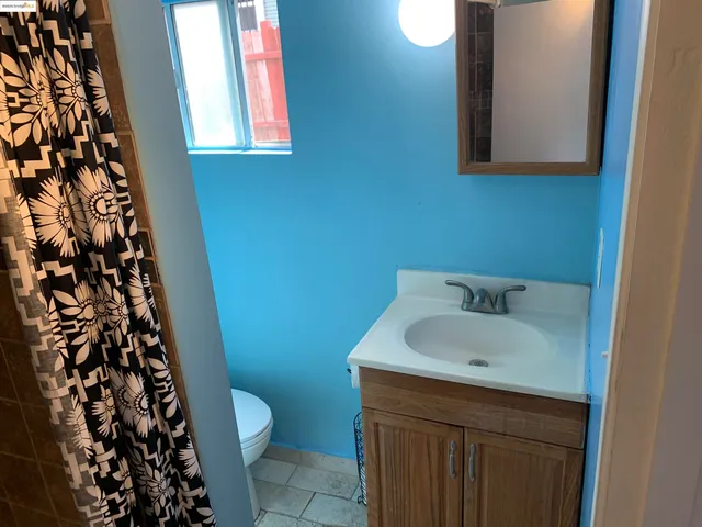 a kitchen with granite countertop a stove a sink and a microwave