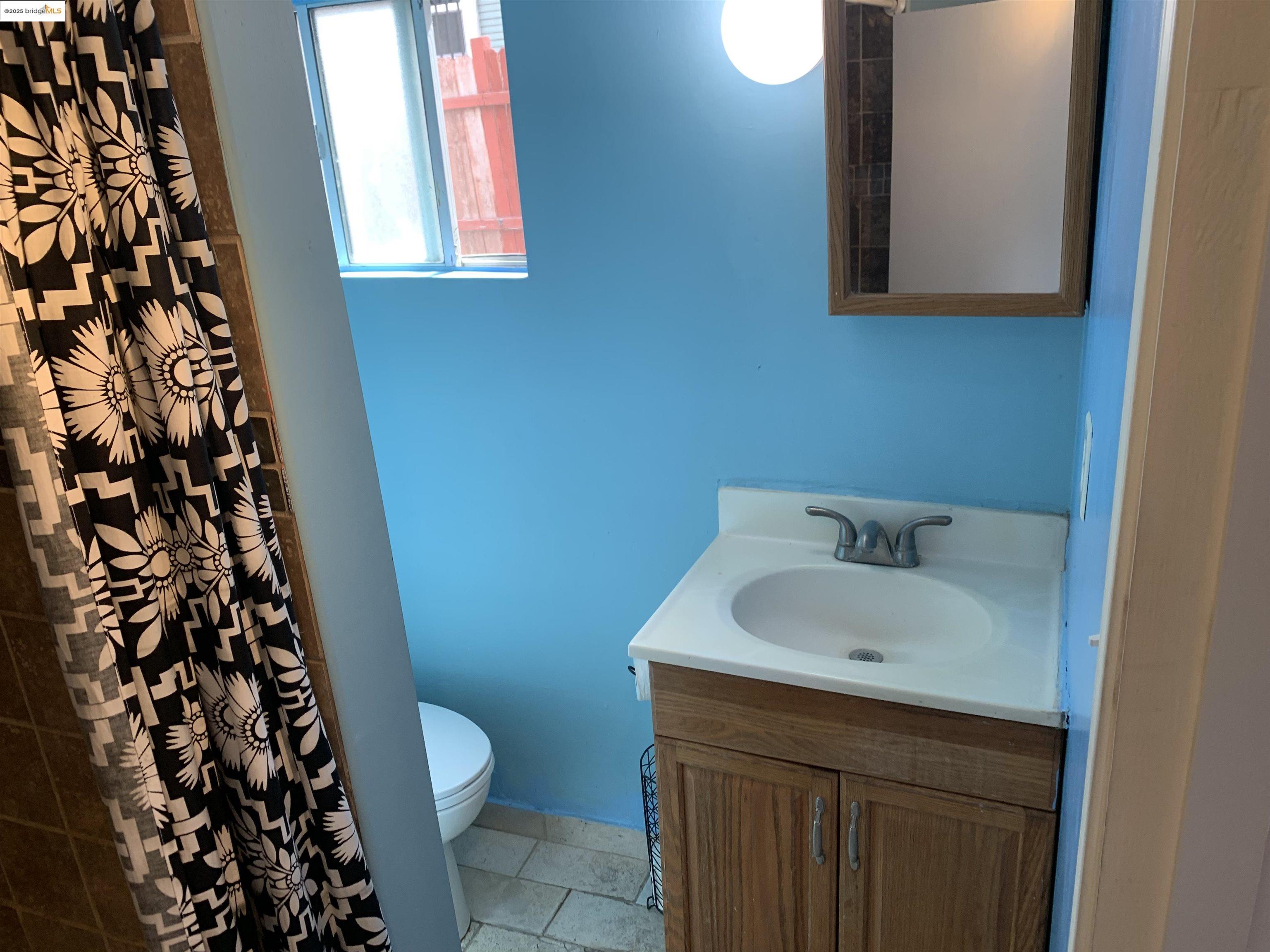 4114 East 17th Street Oakland, CA 94601 - Photo 27 of 39 a bathroom with a sink toilet and shower