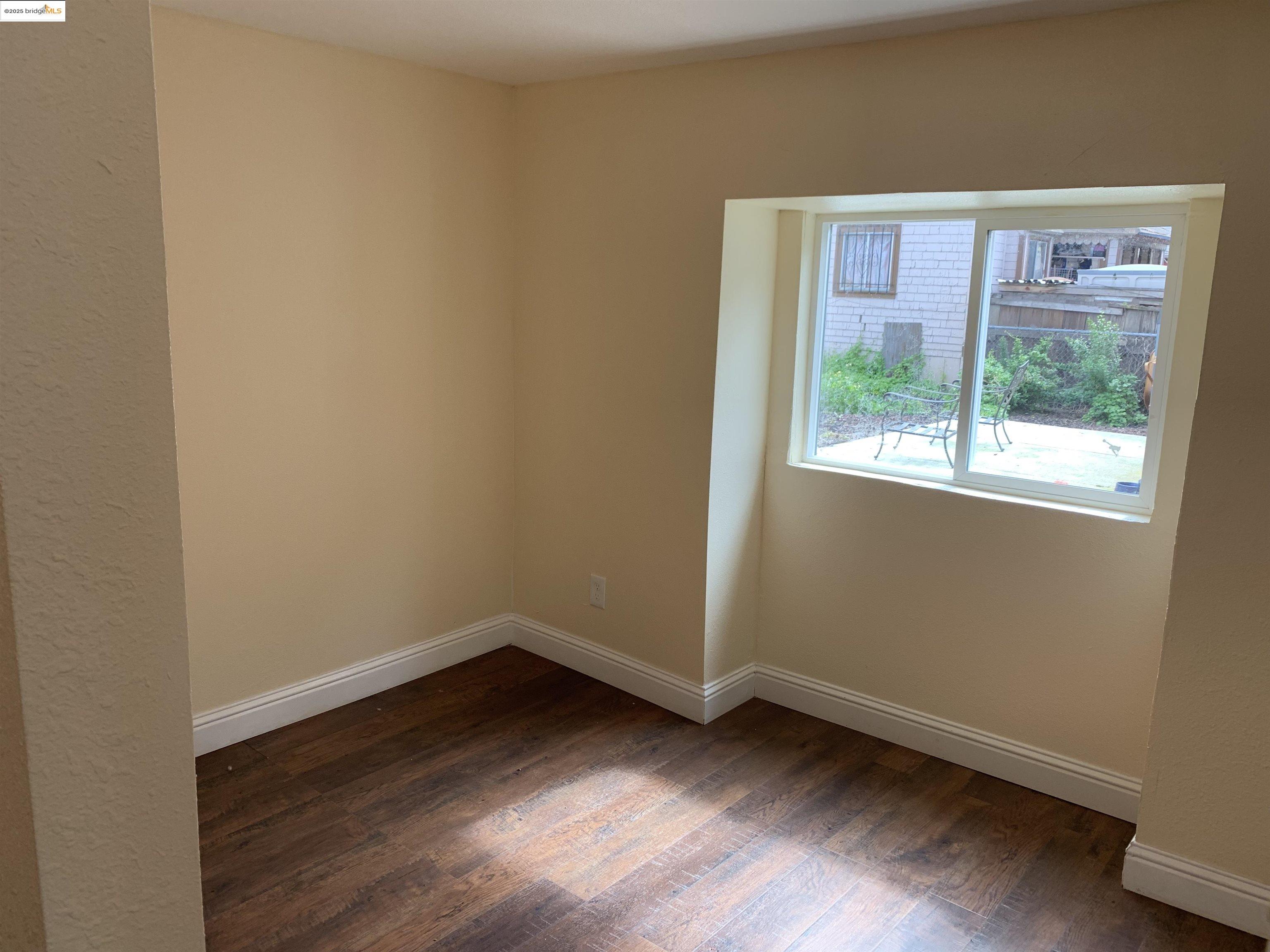4114 East 17th Street Oakland, CA 94601 - Photo 33 of 39 a view of an empty room with wooden floor and a window