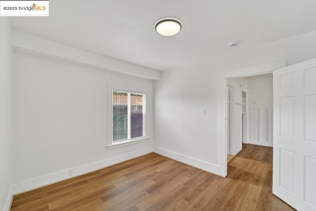 4114 East 17th Street Oakland, CA 94601 - Photo 37 of 39 a view of an empty room with wooden floor and a window