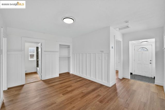 a kitchen that has a lot of cabinets in it and stainless steel appliances