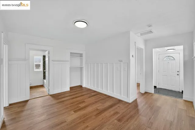 a kitchen that has a lot of cabinets in it and stainless steel appliances