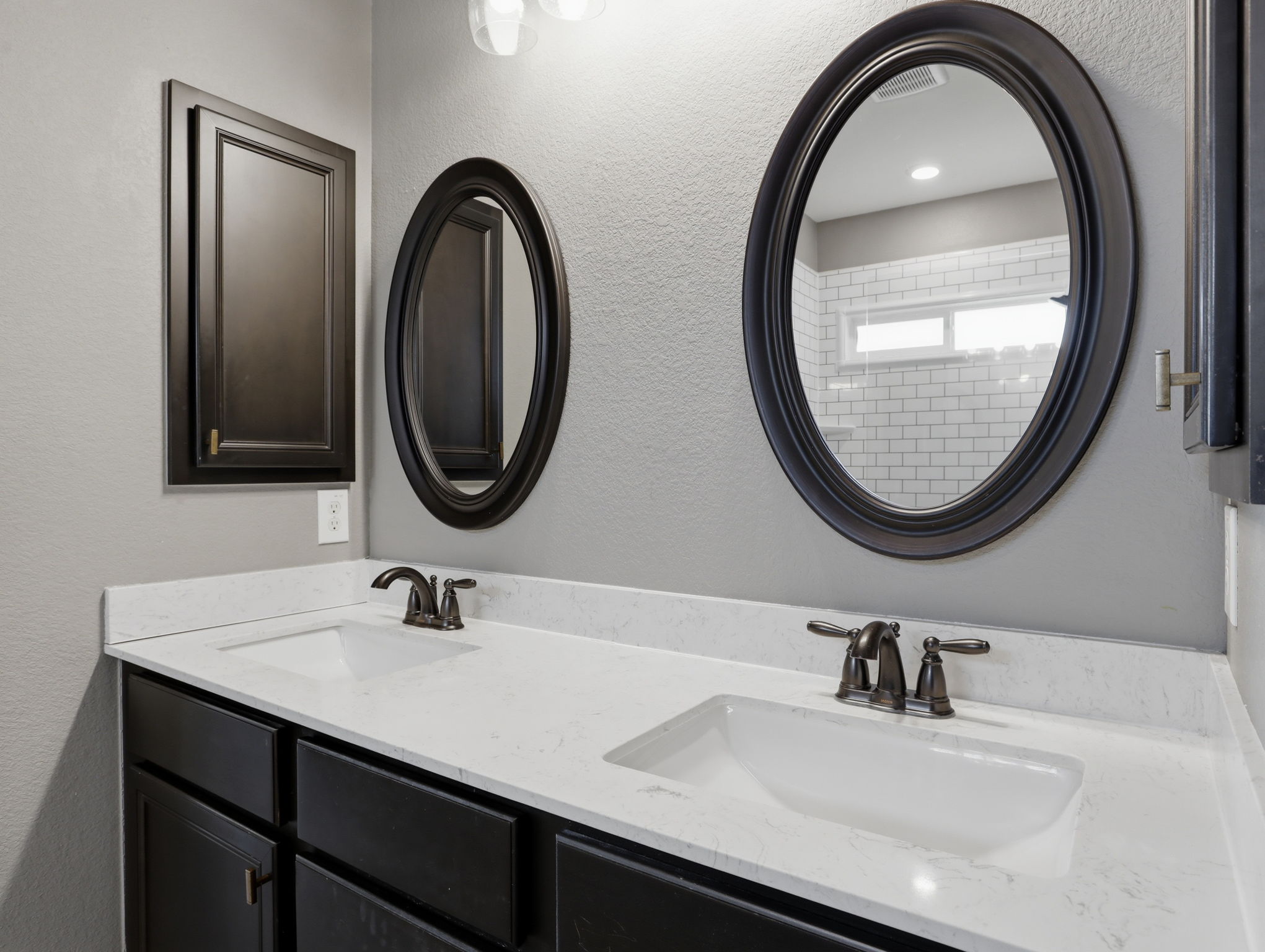 640 Landon Samuel Loop Pflugerville, TX 78660 - Photo 26 of 33 Dual vanity with integrated white sinks, light-toned countertops, and dark cabinetry