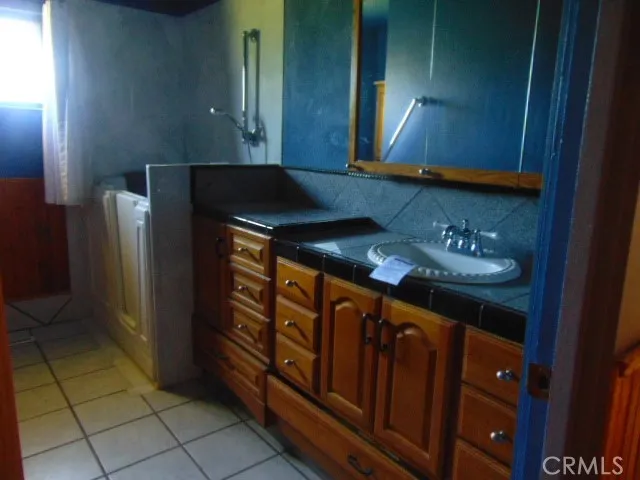 a kitchen with stainless steel appliances granite countertop a refrigerator a stove and a microwave oven