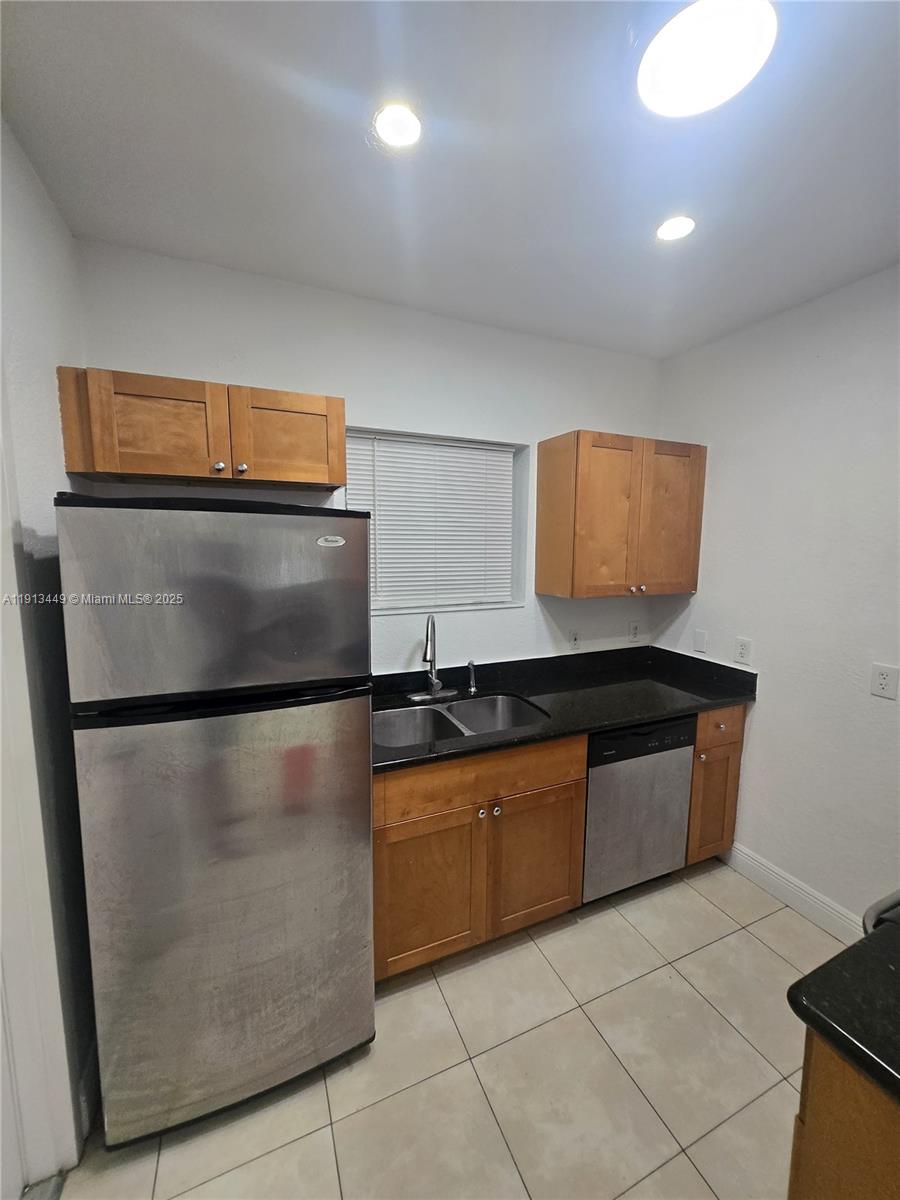 851 80th Street, Unit 4 Miami Beach, FL 33141 - Photo 2 of 9 a kitchen with stainless steel appliances granite countertop a refrigerator and a stove