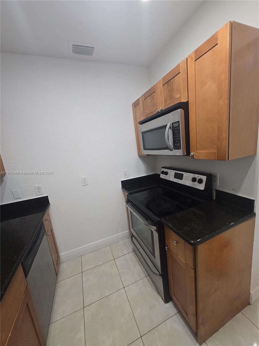 851 80th Street, Unit 4 Miami Beach, FL 33141 - Photo 3 of 9 a kitchen with a stove and a microwave