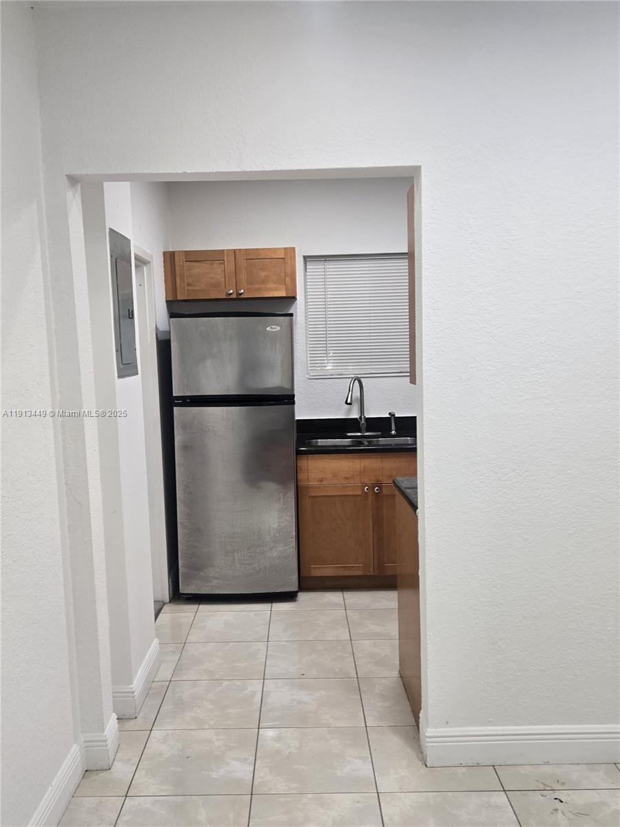851 80th Street, Unit 4 Miami Beach, FL 33141 - Photo 4 of 9 a kitchen with a refrigerator and a refrigerator