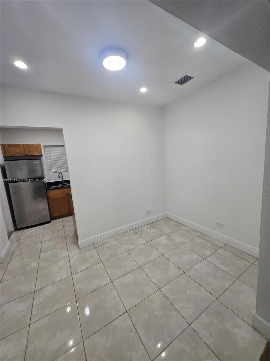 851 80th Street, Unit 4 Miami Beach, FL 33141 - Photo 7 of 9 a view of a livingroom with a couch