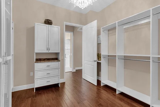 a view of walk in closet with wooden floor