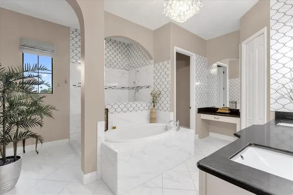 a spacious bathroom with a tub shower and sink