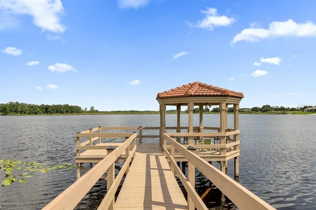 a view of a balcony with wooden floor and lake