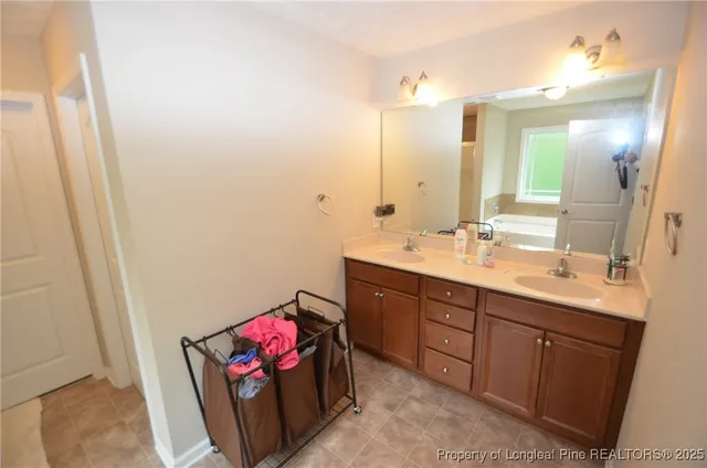 a bathroom with a sink mirror and vanity