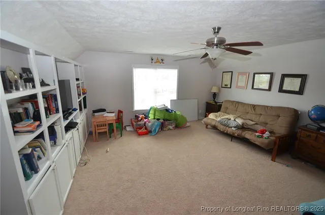 a bedroom with furniture and a book shelf