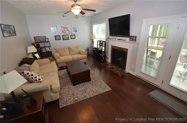 a living room with furniture fireplace and flat screen tv