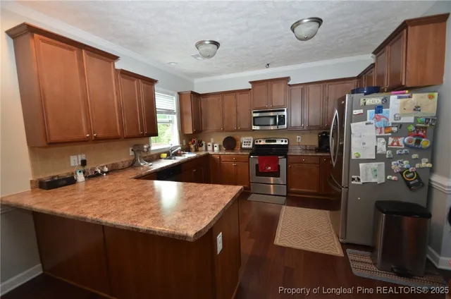 a kitchen with stainless steel appliances granite countertop a sink refrigerator and microwave