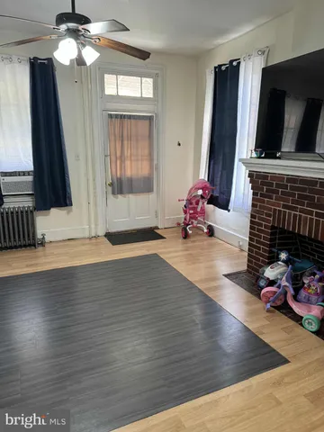 a living room with furniture mirror and flat screen tv