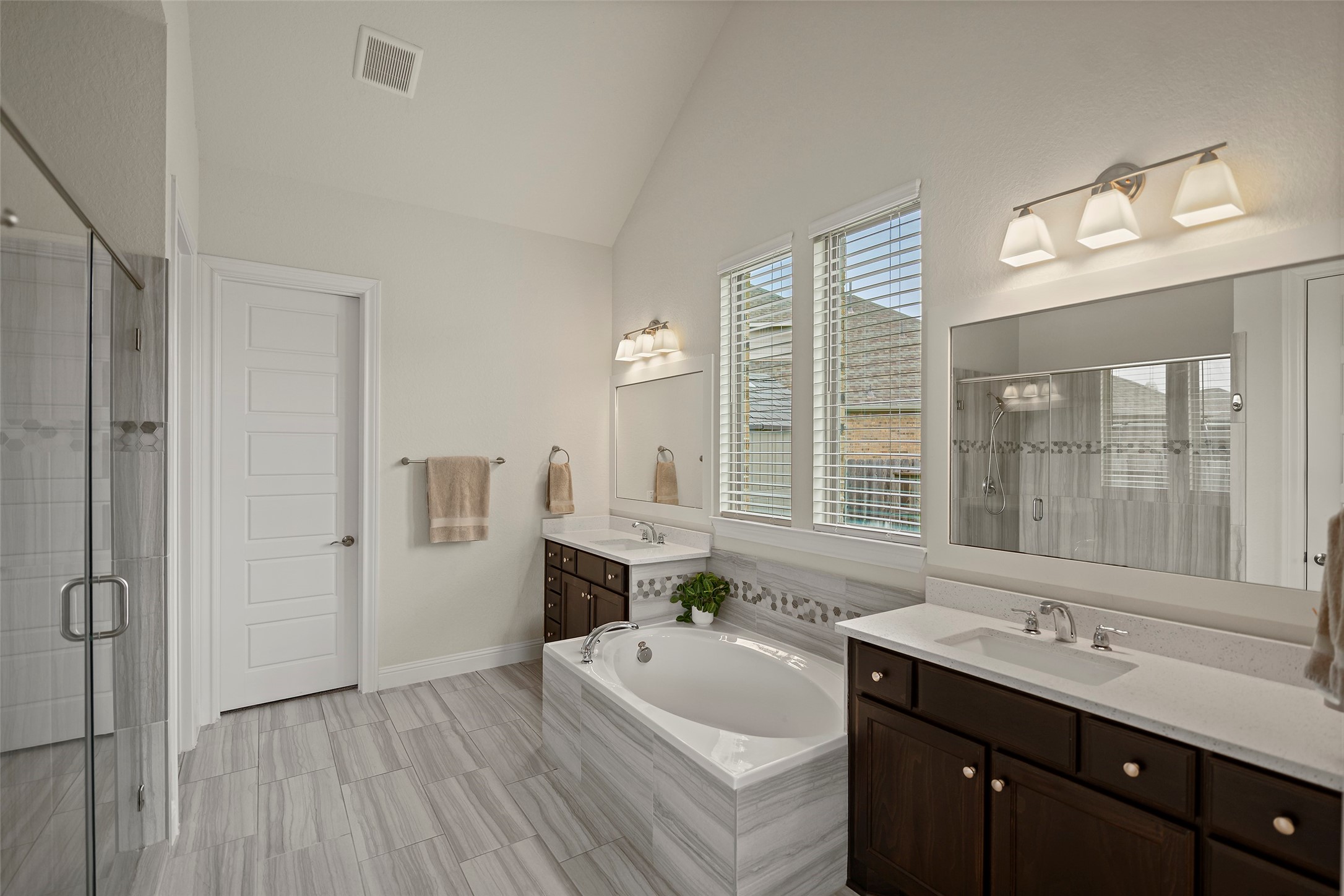 20330 Rosegold Way Spring, TX 77379 - Photo 20 of 48 Luxurious primary bathroom with dual vanities, soaking tub, quartz countertops, and designer tile finishes.