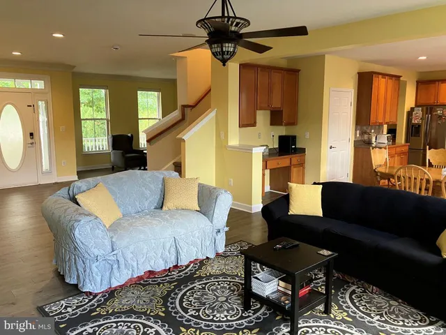 a living room with furniture a rug and a chandelier