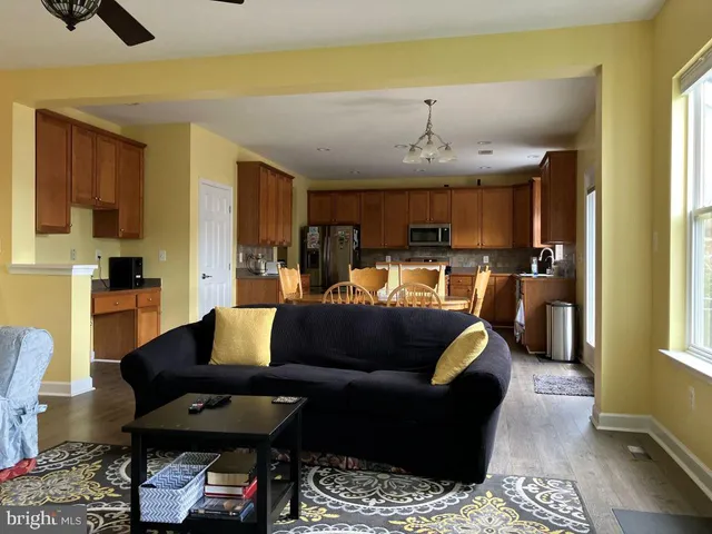 a living room with furniture and a chandelier