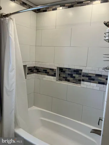 a bathroom with a shower and a sink
