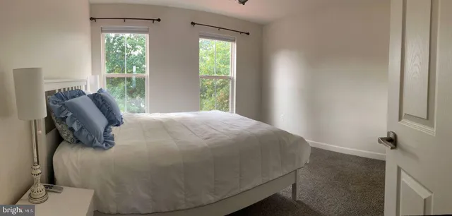 a bed sitting in a bedroom next to a window