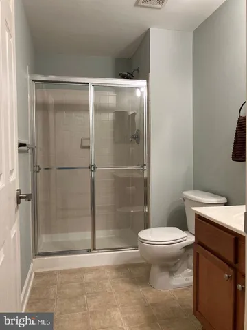 a bathroom with a toilet and a shower