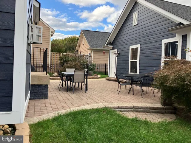 a view of a house with patio and a yard