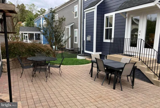 a view of a house with a patio and a yard