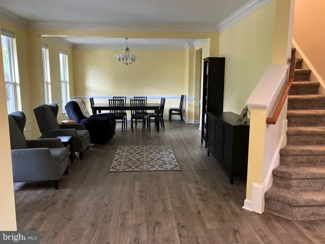 a living room with furniture and a dining table