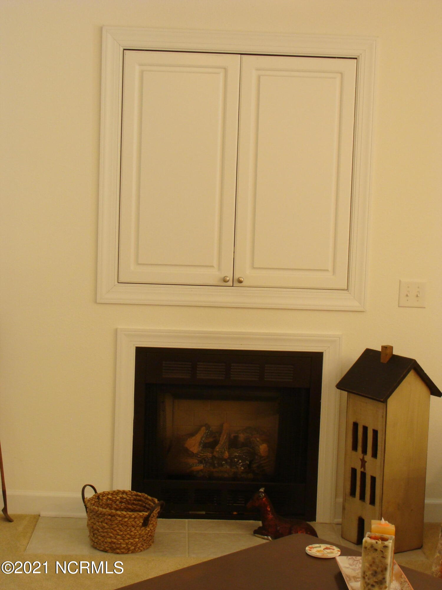 184 Clubhouse Road, Unit 4 Sunset Beach, NC 28468 - Photo 7 of 41 Gas log fireplace with TV storage above.