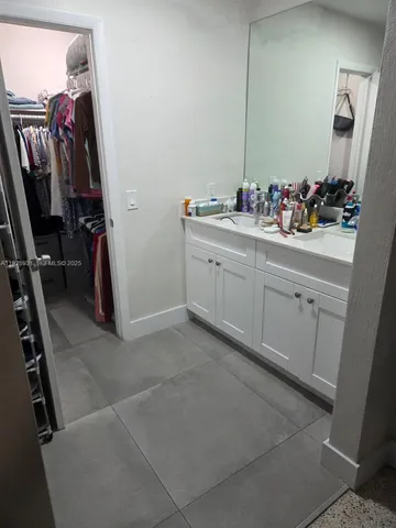 a bathroom with a sink and mirror