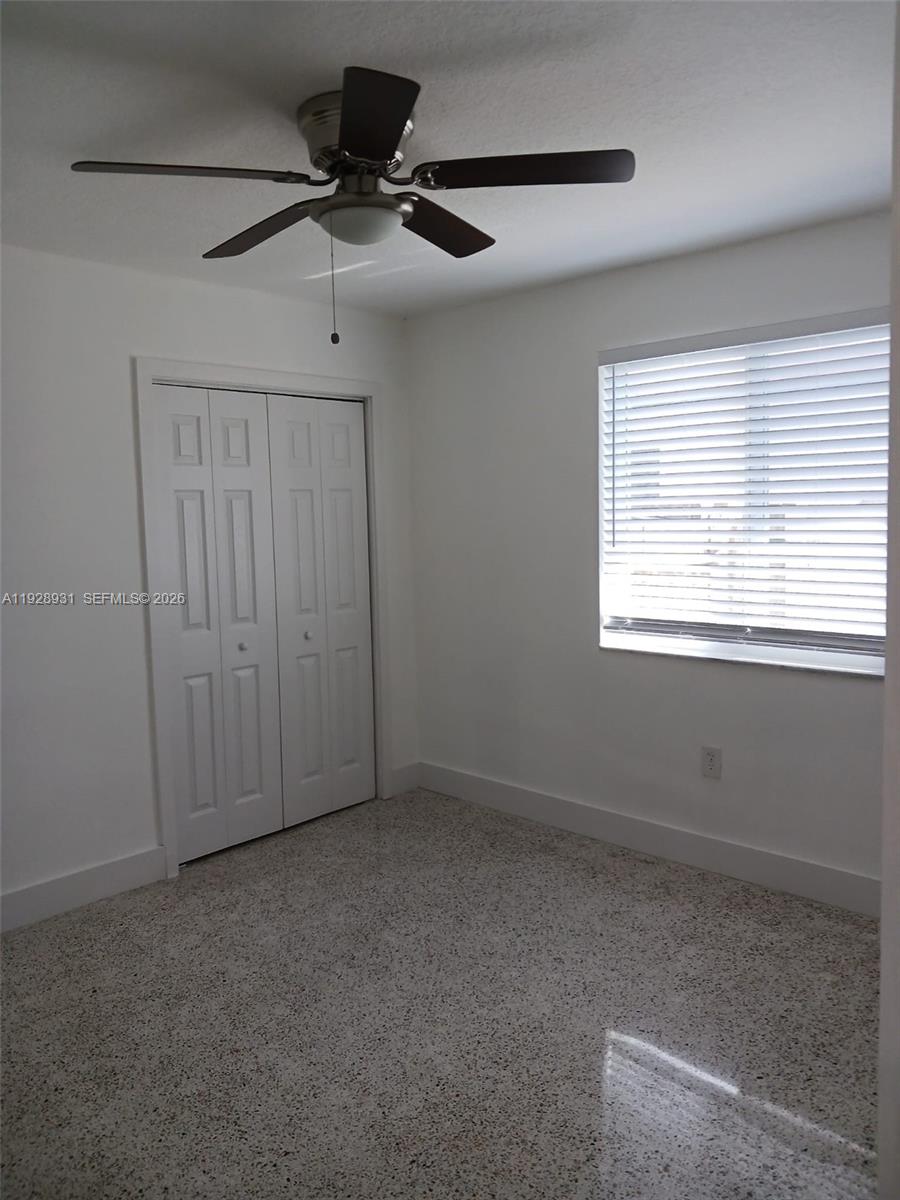 9228 Southwest 37th Street, Unit 9228 Miami, FL 33165 - Photo 12 of 25 a view of an empty room with a window