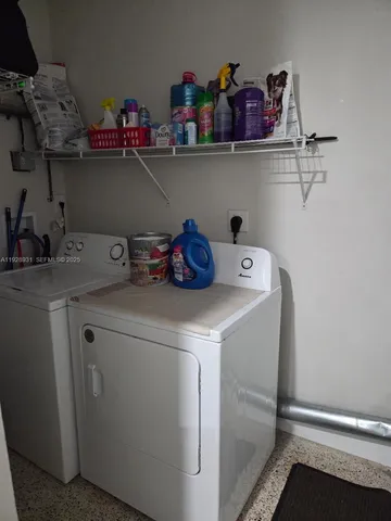 a view of storage and utility room with washer and dryer