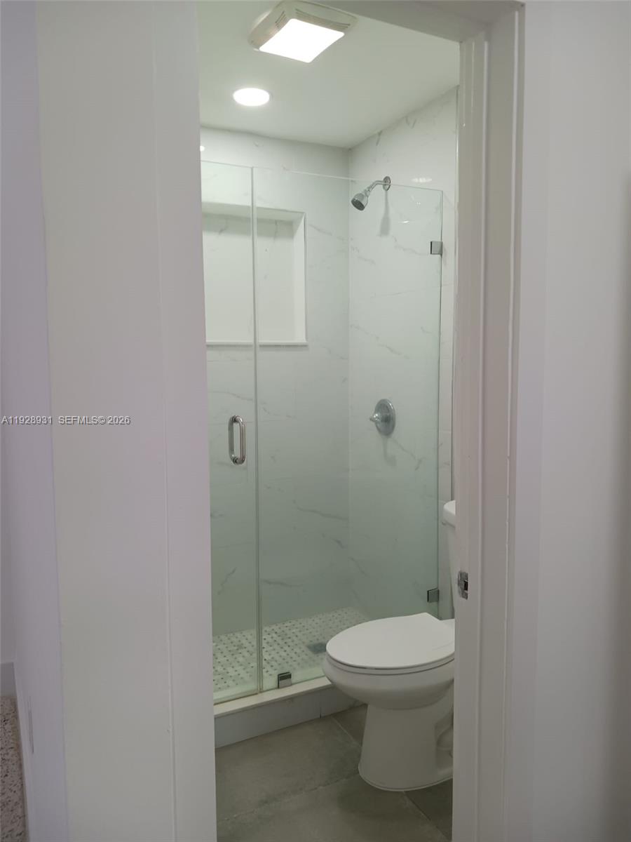 9228 Southwest 37th Street, Unit 9228 Miami, FL 33165 - Photo 20 of 25 a bathroom with a toilet a sink and shower
